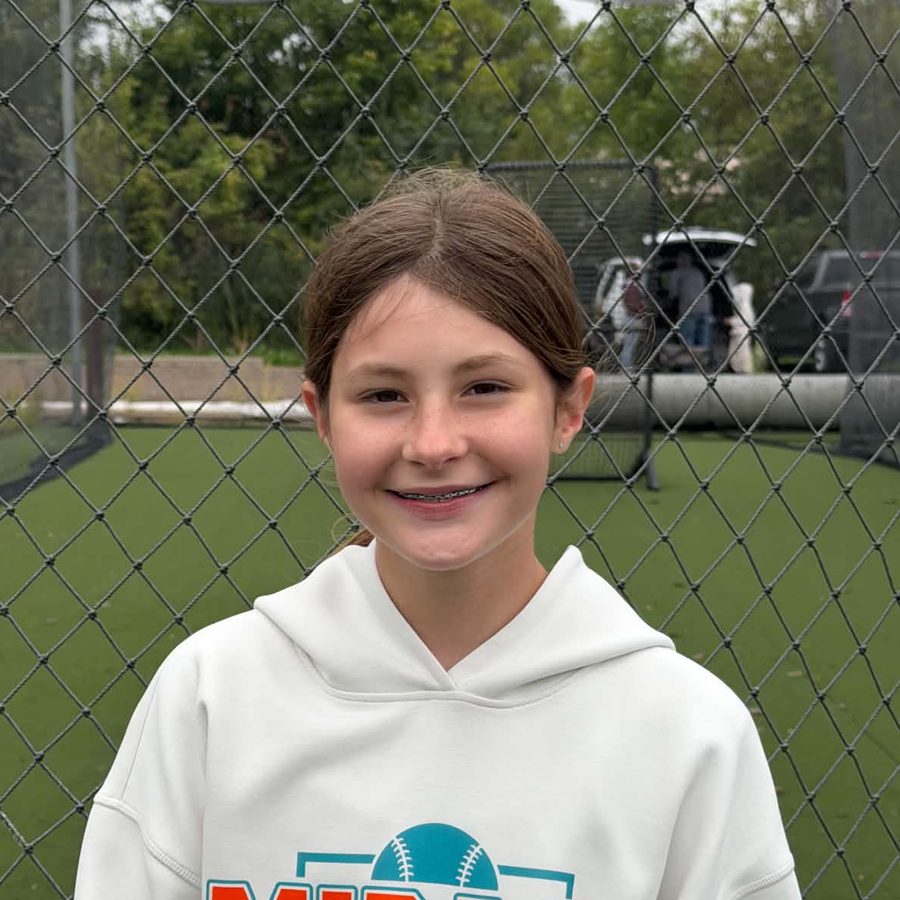 Amelia S. in a Mirage Softball hoodie at the batting cages